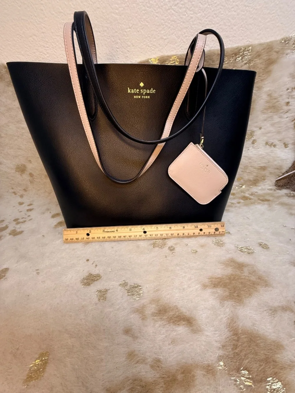 Stylish Kate Spade reversible tote in classic black with blush pink interior